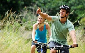 A happy couple riding their bikes